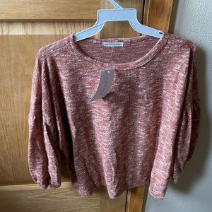 Peach blouse with 3/4 length sleeves.